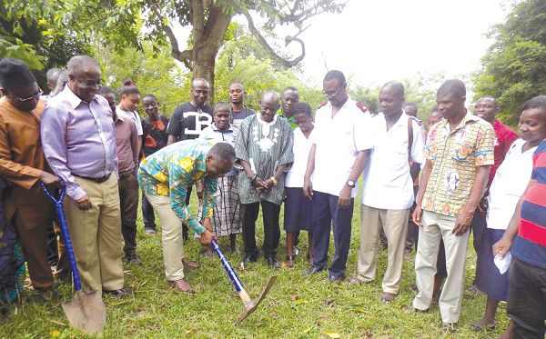 Mr William Agyapong Quaittoo (with pick axe in hand) cutting the sod for commencement of the projects. Picture: SAMUEL KYEI-BOATENG