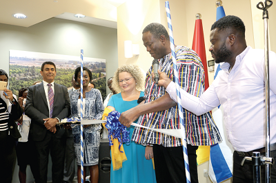 Mrs Shani Cooper-Zubida (3rd left) being  assisted by  Mr Samuel Kofi Ahiave Dzamesi (2nd right) to cut the tape to inaugurate the office. Picture: Severious Kale-Dery