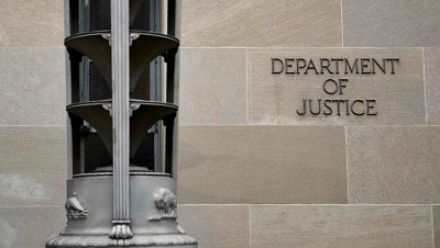 A sign is seen on the Department of Justice building in Washington, DC on November 7, 2018.