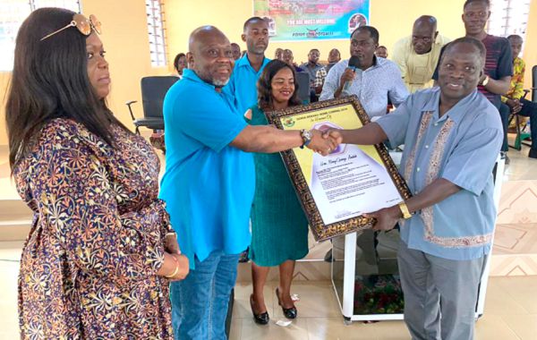Prof. Alfred Anderson (right), a Senya citizen based in the US, presenting the citation to Mr Andah (2nd left)