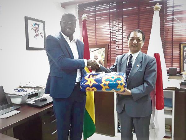 Mr Frank Annoh-Dompreh (left) presenting a Kente cloth to Mr Tsutomu Himeno