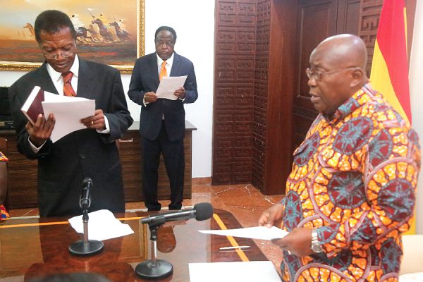  President Nana Addo Dankwa Akufo-Addo (right) swearing in Mr Mensah Demitia (left) at the Jubilee House. Picture: SAMUEL TEI ADANO