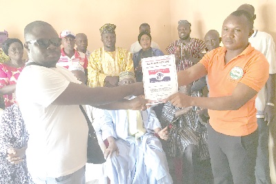 Mr Richard Oduro (left), the NPP Polling Station Organiser, Acherensua Day Nursery, receiving the nomination forms from Mr Mohammed Alhasan (right), a Research Officer, Asutifi South NPP, on behalf of Mr Ali Suraj, at the NPP office at Hwidiem