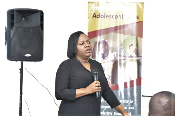 Some of the parliamentarians listening to Ms Erika Goldson (right), the Deputy Country Representative of UNFPA, Ghana, during her presentation 