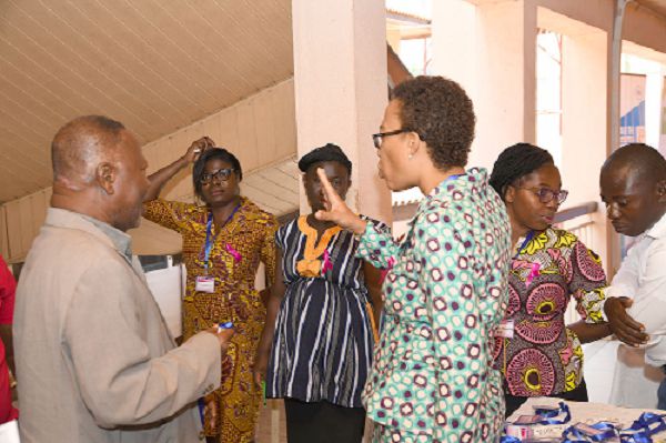 Dr Florence Dedey sharing a perspective with some members of the Breast Society after the opening session of the Annual General Meeting of the society in Accra. Picture: EBOW HANSON