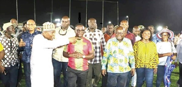 Mr Robert Coleman (arrowed), the Chief Executive Officer of Wembley Sports Construction, conducting President Akufo-Addo round the Madina Artificial Football Park complex. With them are Mr Abubakar Boniface Siddique, Minister of State at the Office of the Vice President (left) and other officials