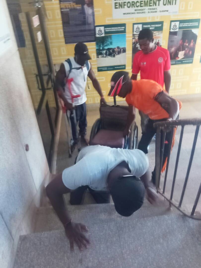 A physical challenged person going through hell to use the steep stairs at Youth Employment Agency (YEA)