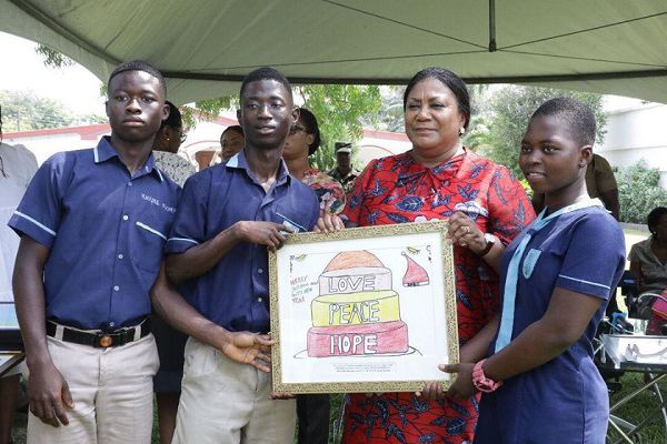Mrs Rebecca Akufo-Addo, First Lady, receiving artwork from students of the Demonstration School for the Deaf, Akropong