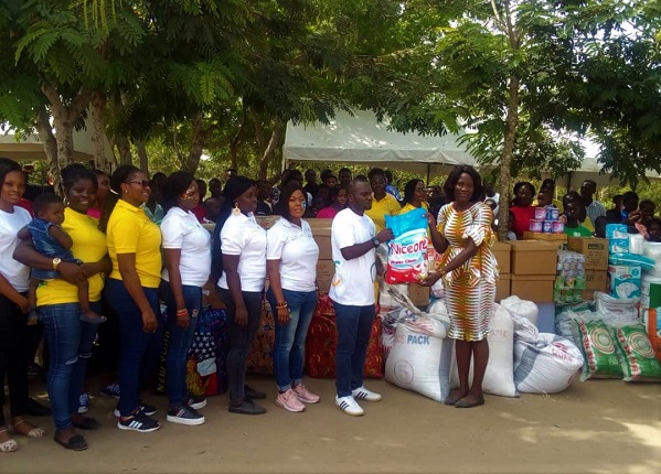 Mr Nicholas Cofie center (left) handling over the items to Mrs Naomi Amoah right
