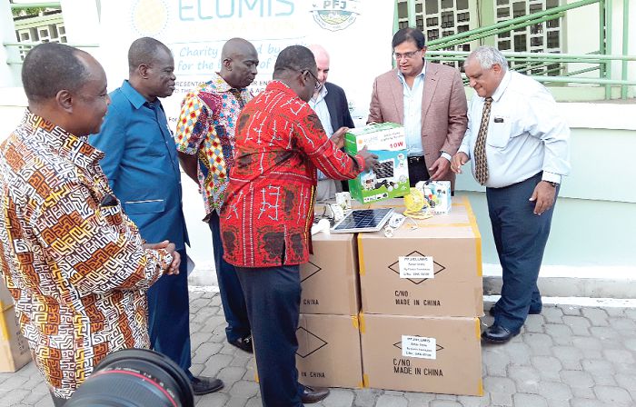  Dr Owusu Afriyie Akoto (3rd left) examining the products, while officials of both the ministry and Elumis look on