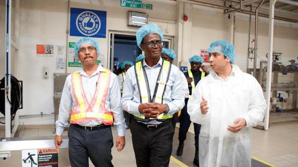 Mr Ajit Patil (left), General Manager of Nutrifoods, and Mr Hitesh Makhija, Country Finance Controller of the company, leading Mr Owusu-Amoah (middle) on a tour of the factory. Picture: Della Russel Ocloo