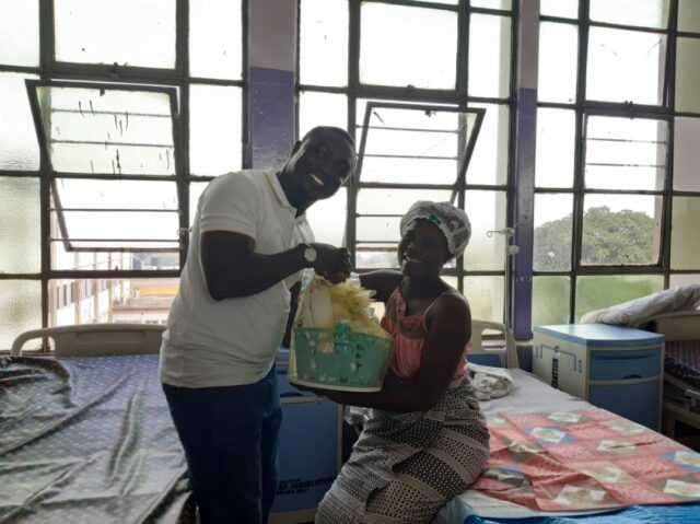 Mr Kwasi Osei Hyeaman presenting a hamper to one of the fresh mothers.