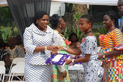 Mrs Vivian Biney-Aidoo left presenting a prize to a student at the programme.