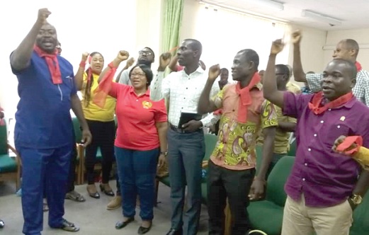 Health workers in red bands singing at the Koforidua meeting
