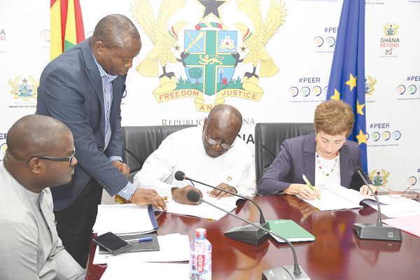 Mr Ken Ofori-Atta (2nd right), Minister of Finance, and Ms Diana Acconcia, EU Ambassador to Ghana, signing documents for the EU grant of €40 million to Ghana. Picture: EBOW HANSON