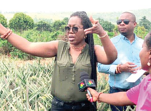 Ms Afua Asabea Asare (hands stretched) during her  visit to Lovely Farms