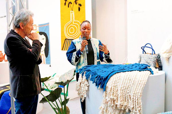 Mr Maier-Aichen (left) listening to Ms Awa Miete of Mali on how she creates her designs from cotton. PIX: DELLA RUSSEL OCLOO