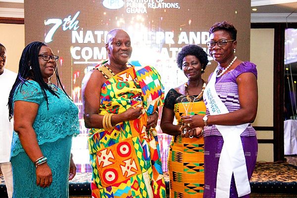 Ms Adiki Ofeibea Ayitevie (right) displaying the PR Personality of the Year award presented to her by Nana Otuo Siriboe II (2nd left), the Chairman of the Council of State. Those with them are Ms Elaine Sam (3rd left), President of the Institute of Public Relations (IPR), and Madam Cynthia Ofori Dwumfuo (left), PR Business Lead, Ogilvy Ghana. Picture: BENEDICT OBUOBI