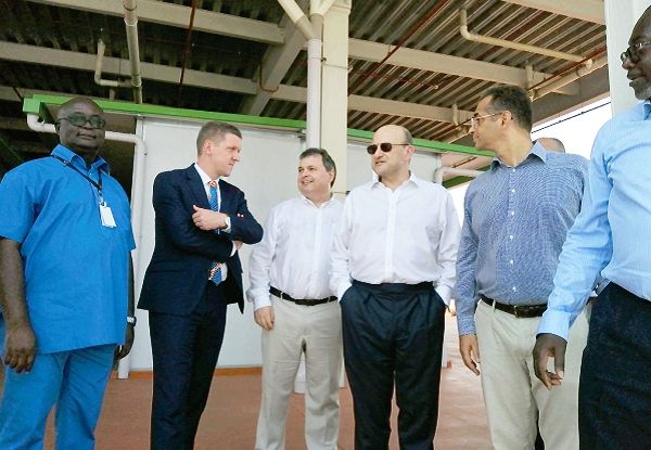  Mr Louis Taylor (3rd right) with the contractors. On his right in suit, is Mr Iain Walker, British High Commissioner to Ghana