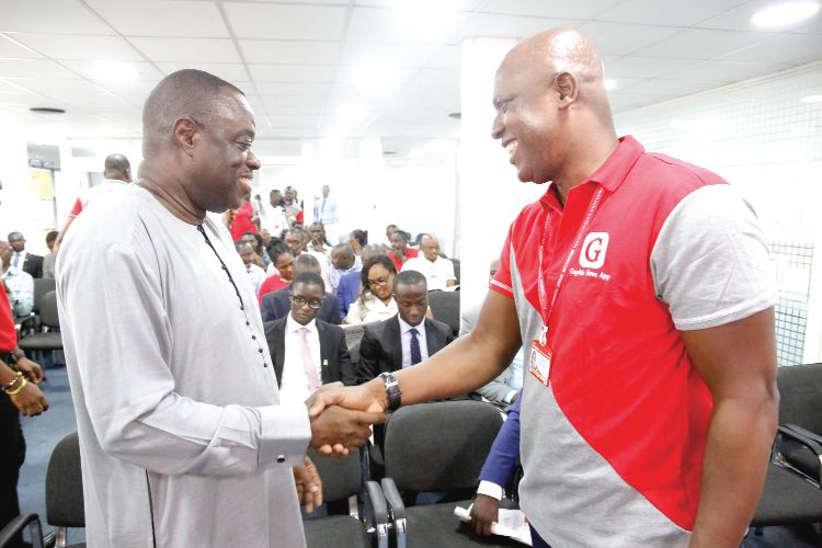  Dr Mohammed Ibrahim Awal (left) in a handshake with Mr Ato Afful at the launch of the Tertiary Business Sense Competition in Accra. Picture: SAMUEL TEI ADANO