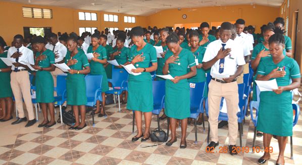 Mr Raymond Kunsu (inset) administering the matriculation oaths to the students