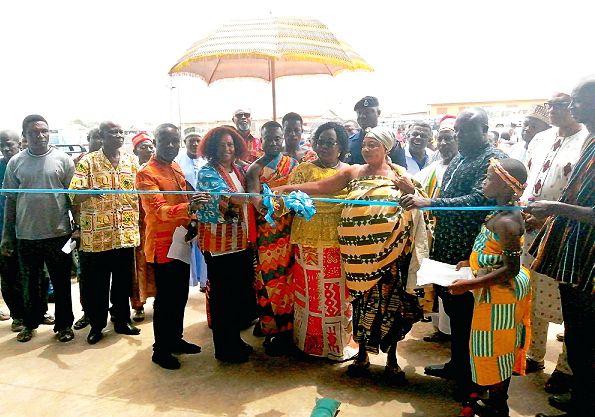 Ms Rukia Yacoub (4th left) being assisted by Madam Elizabeth Agyeman (4th right) and other dignitaries to inaugurate the warehouse. INSET: The warehouse