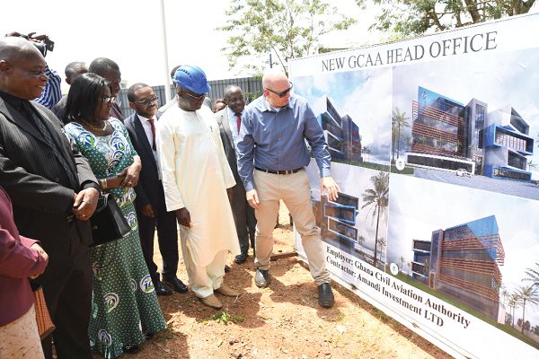 Mr Yoed Chizik, the Business Development Director of Amandi Investments Limited, showing Mr Kofi Adda, an artist’s impression of the proposed headquarters of the GCAA during the sod-cutting ceremony at the Kotoka International Airport. Picture: EBOW HANSON 