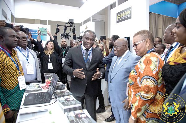 President Nana Addo Dankwa Akufo-Addo (2nd right) being briefed by Mr Eric Asubonteng, CEO of Anglogold Ashanti, at the Ghana pavilion at an exhibition mounted as part of the conference