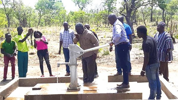 Professor Frimpong-Boateng drinking water from a mechanised borehole