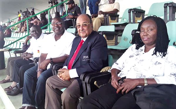   Some Ghanaian fans and an official from the International Hockey Federation at the Abuja national stadium during the 2018 ACCC hockey tournament 