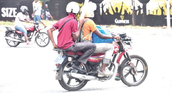 Some Okada riders on a road