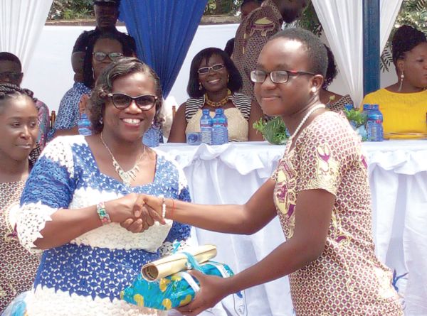 Ms Lady Queene Asiedu-Akrofi (left), Headmistress of the Presbyterian Boys’ Senior High School (Presec), Legon, presenting an award to Ms Naomi Aboagye Dacosta (right), the Overall Best Student.Picture: ESTHER ADJEI
