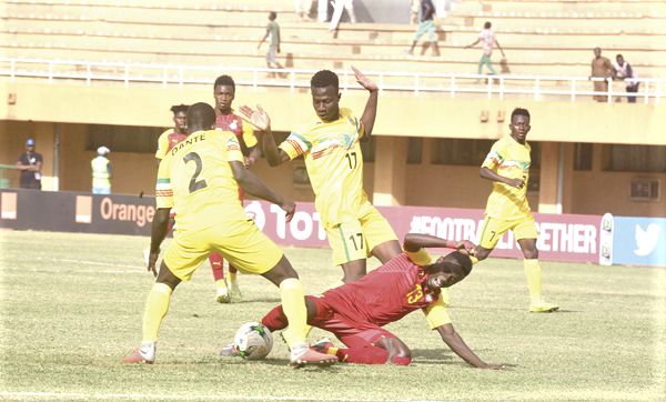 Young Eagles duo Amadou Dante (left) and Mamadou Samake(17) battle with Michael Baidoo of Black Satellites
