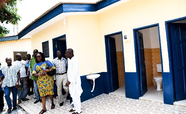  Mrs Ursula Owusu-Ekuful being conducted round the 16-seater toilet facility by some police personnel at the Dansoman Police Station. Picture: EBOW HANSON   