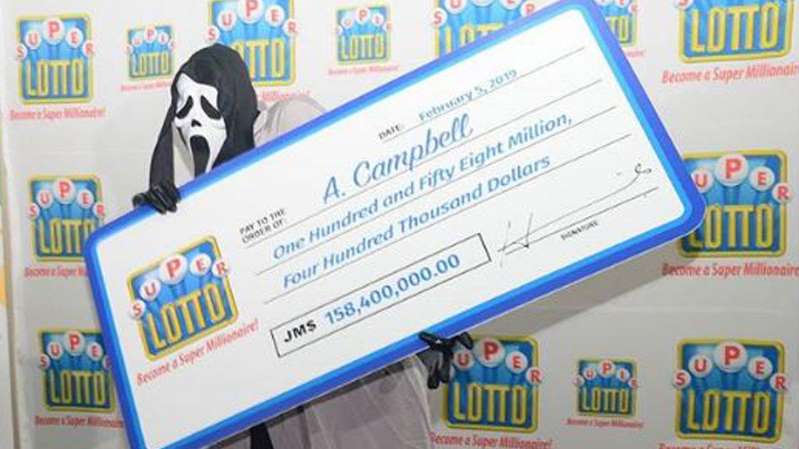 Lottery winner picks up prize wearing mask