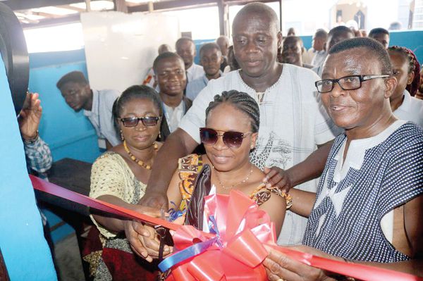 Prof. Baffour Agyemang Duah (right) assisting CSP Hanna Hilda Ewoame (middle) to cut the tape to inaugurate the refurbished library facility at the Kumasi Prison. Those with them are Mrs Elisabeth Ankomah (left), Regional Director, the Ghana Library Authority, and Mr Samuel Owusu Amponsah (behind), a Deputy Director of Prisons (DDP). LEFT: A section of the library facility. Pictures : EMMANUEL BAAH