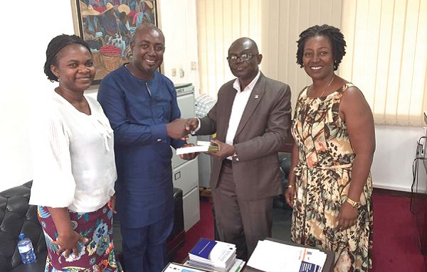 Prof. Micah (2nd left), Pro Vice Chancellor of TTU, receiving the books from Prof. Asante. With them are Ms Emefa Amponsah (left), a lecturer at TTU and Ms Eccles Andoh, Administrative Secretary, ISSER 