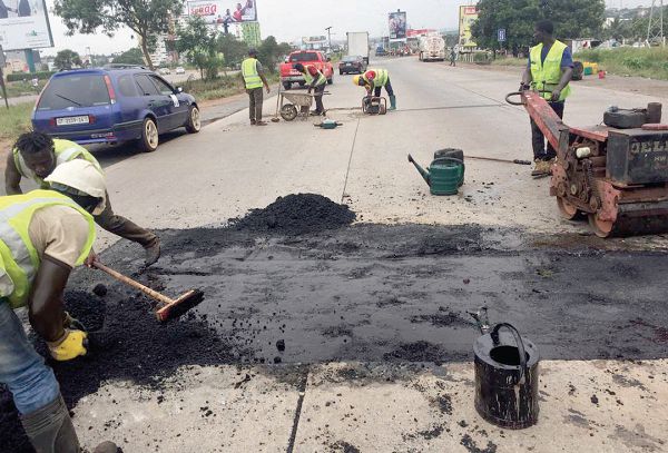Workers of the Sasecom Ltd sealing potholes on the motorway
