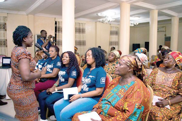 Miss Yaa Tiwaa Amoah (left), a Deputy Head of the Post-Harvest Unit at the Fisheries Commission, speaking to the women at the programme