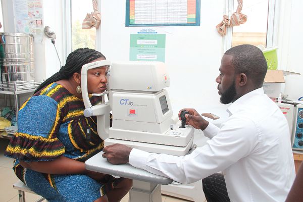 Dr Haryana Yakubu Zato, Optometrist, LeKMA Hospital screening a resident.  Picture: BENEDICT OBUOBI