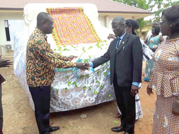 Mr Gabriel Kyeremeh (left) handing over the ambulance to Alhaji Abuu, MCE for Jaman South. INSET: The ambulance