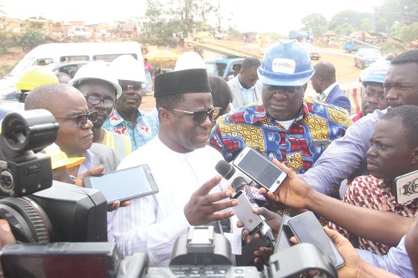 Some engineers working on the high-tension pylons at Pokuase. INSET: Mr John-Peter Amewu briefing the press during a visit to Pokuase, where works were ongoing on some high-tension pylons. Mr Jonathan Amoako-Baah, the Chief Executive of the Ghana Grid Company Limited (GRIDCo). Picture: Maxwell Ocloo