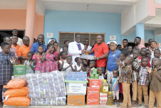 Archbishop Prof. Dr Anane Frempong (middle) hands over the items to a beneficiary home