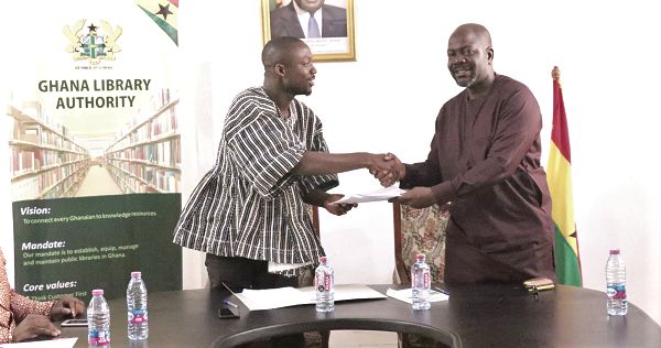 Mr Hayford Siaw (left) receiving the MoU from Mr Rene Gameli-Kwame.