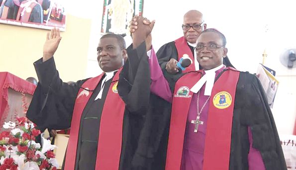 The Rt. Rev. Prof. Joseph Edusa-Eyison (right) presenting The Very Rev. Felix Tawiah Korankye Danquah to the church after the induction