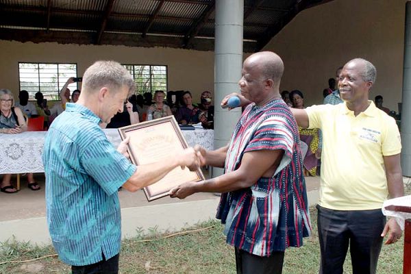 Mr John Norgah (middle), Chairman for the function, presenting a citation to Mr Martin Leskov. Looking on admiringly is Mr Joshua Nyumuah Nartey