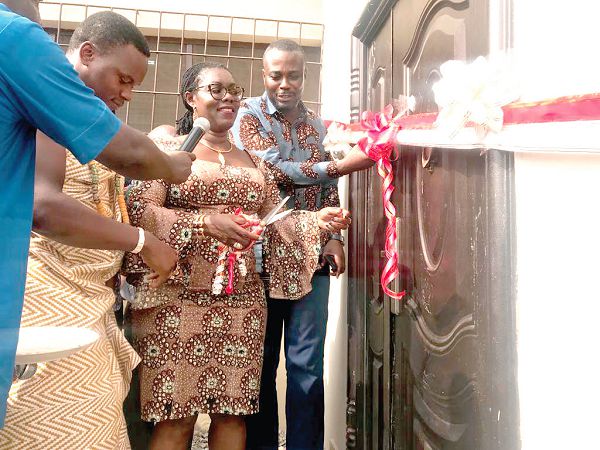 Mrs Ursula Owusu-Ekuful (middle) cutting the tape to inaugurate the project