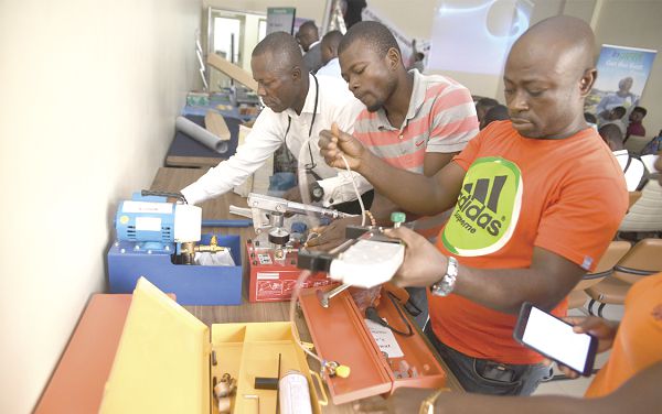 Representatives of a sanitary ware manufacturing company in Ghana setting up their stand at the ceremony