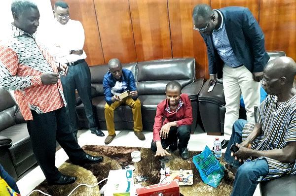 Samuel Naamgwinaa showcasing his inventions to the admiration of Prof. Kwabena Frimpong Boateng and others