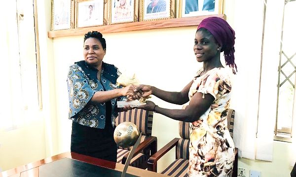  A member of the GFA Normalisation Committee, Naa Odofoley Nortey (left), presenting the award to Mukarama Abdulai